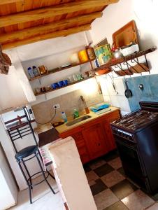 a kitchen with a stove and a sink at Alojamientos Lilu in Colón