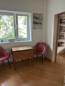 a living room with a table and two chairs and a window at Karmel Apartment in Warsaw