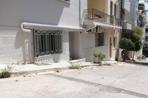 a building with a gate on the side of a street at Elegant studio at the Acropolis hills in Athens
