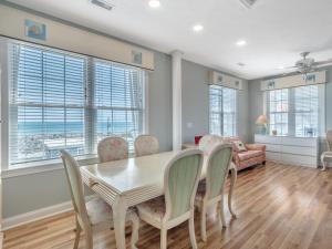 a dining room with a table and chairs and a couch at Skippers Hideout in North Topsail Beach