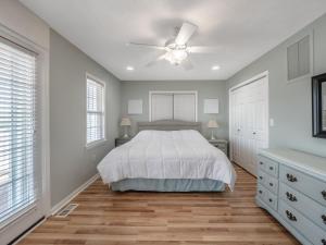 a bedroom with a bed and a ceiling fan at Skippers Hideout in North Topsail Beach +17 photos