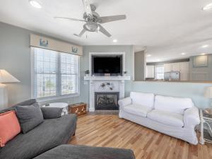 a living room with a couch and a fireplace at Skippers Hideout in North Topsail Beach