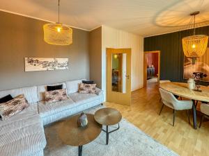 a living room with a couch and a table at Moor Feeling Apartments Worpswede in Worpswede