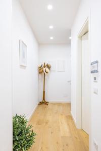um corredor com um candeeiro de chão num quarto branco em Residence Panoramic em Maiori