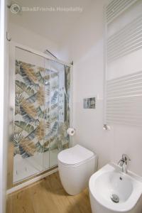 a white bathroom with a toilet and a sink at CASA CAMILLA in Pesaro