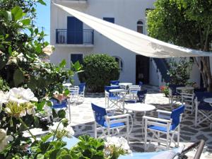 a patio with chairs and tables and a white canopy at Angelina Greek House in Parikia