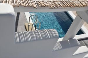 a view of a pool from a chair on a boat at Tinos Portraits Ballos in Agios Romanos
