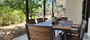 a wooden table with glasses of wine on a patio at Sylvia's house at Vagia in Vaia