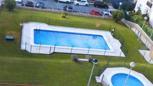 an overhead view of a large swimming pool in a yard at R2R - Apartmento Aire del Mar - C11A02 in Liencres
