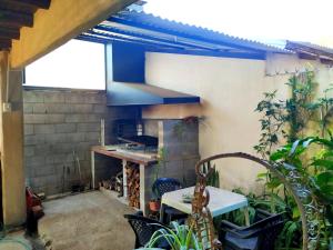 an outdoor kitchen with a stove and a table at Alojamientos Lilu in Colón