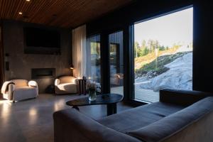a living room with a couch and a large window at Villa Blackwood in Söderkulla