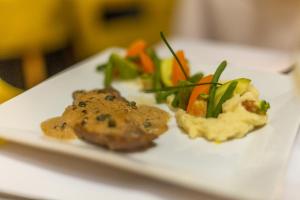 a plate of food with vegetables on a table at Hotel Vents Des Iles in Essaouira