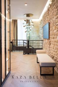 a room with a bed and a bench and a window at KAZA BELLA - Haut Marais Modern flat with small pool in Paris