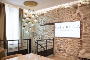 a room with a stone wall with a sign on it at KAZA BELLA - Haut Marais Modern flat with small pool in Paris