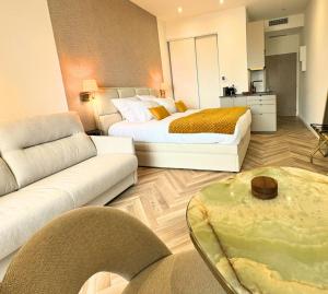a hotel room with two beds and a living room at Luxury Suite Monaco SeaView Terrace and Pool in Beausoleil