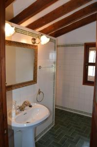 a bathroom with a sink and a mirror and a shower at Bonita casa de campo típica Mallorquina in Sant Jordi