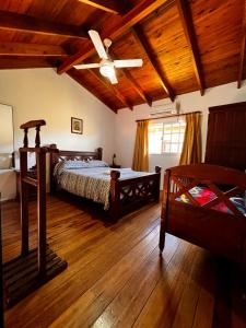 a bedroom with a bed and a ceiling fan at Las Glicinas in Federación +42 photos