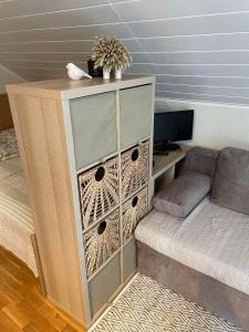 a bedroom with a dresser next to a bed at EVA Studio in Palanga