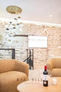 a room with two chairs and a table with a bottle of wine at KAZA BELLA - Haut Marais Modern flat with small pool in Paris