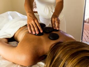 a woman getting a back massage on a bed at NOI Casa Atacama in San Pedro de Atacama