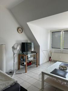 a living room with a tv and a table at Jasmin’s Apartment in Krefeld