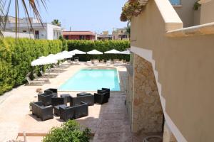 a swimming pool with lounge chairs and umbrellas at b&b Villa Grazia in Leverano +13 photos