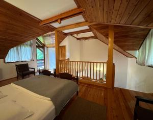 a bedroom with a bed and a wooden ceiling at Casa Edelweiss in Sinaia