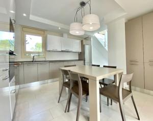 a kitchen with a table and chairs in a kitchen at Vistamar in Les tres Cales +14 photos