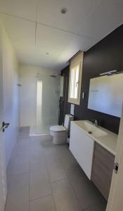 a bathroom with a toilet and a sink at Vistamar in Les tres Cales