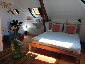 a bedroom with a bed and a vase with flowers at Château Machiel Chambre d hotes de charme au calme en Baie de Somme in Machiel
