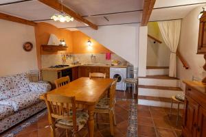 a kitchen and living room with a table and a couch at Casa Castel del Monte in Castel del Monte
