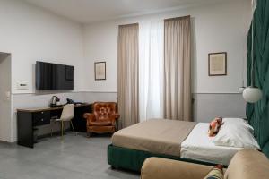 a hotel room with a bed and a desk at Hotel San Michele in Naples