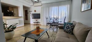 a living room with a couch and a table at Appartement marina hammamet in Yasmine