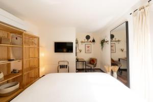 a bedroom with a white bed and a desk at Modern Lake Como Apartment by Honey Homes in Sala Comacina