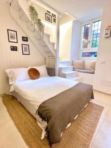 a bedroom with a bed and a staircase at Modern Lake Como Apartment by Honey Homes in Sala Comacina