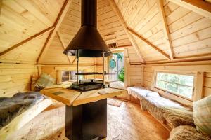 a large room with a stove in a wooden cabin at Private luxurious apartment in Easthampstead