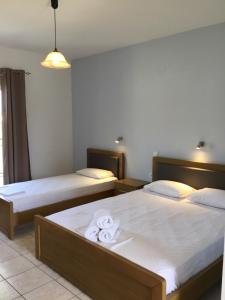 Postel nebo postele na pokoji v ubytování Pothos Hotel Alykes