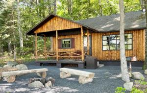 a wooden cabin in the middle of a forest at Mountain Springs Lake Resort in Stroudsburg