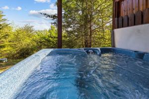 a hot tub in the backyard of a house at Mountain Paradise by Eden Crest in Sevierville