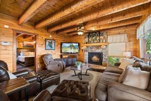 a living room with leather furniture and a fireplace at Mountain Paradise by Eden Crest in Sevierville