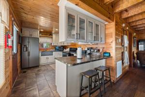 a kitchen with white cabinets and a refrigerator at Mountain Paradise by Eden Crest in Sevierville +57 photos