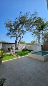 a backyard with a swimming pool and a tree at for in Puerto Vallarta
