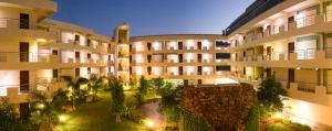an apartment building with a courtyard with trees and lights at Sterling Yelagiri in Yelagiri