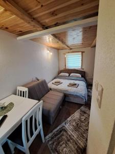 a small room with a bed and a couch at Mountain Life in Žabljak