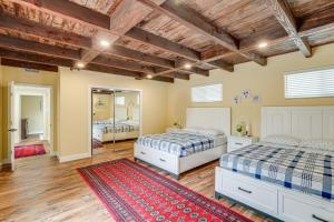 a bedroom with two beds and a red rug at Del Rey Oaks Vacation Home with Mini-Golf Course! in Del Rey Oaks