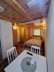 a bedroom with a bed and a table and chairs at Mountain Life in Žabljak