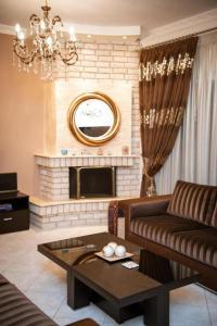 un salon avec un canapé et une cheminée dans l'établissement Vosinakis House in Volos, à Vólos