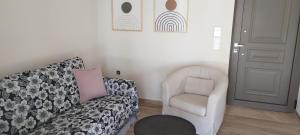a living room with a couch and a chair at Zephyros Villas - Agios Nikitas in Agios Nikitas