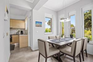 a kitchen and dining room with a table and chairs at Villa Blue Dreams in Maleme in Ayiá