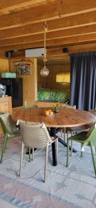 a wooden table and chairs in a living room at The Poolhouse in Buitenpost